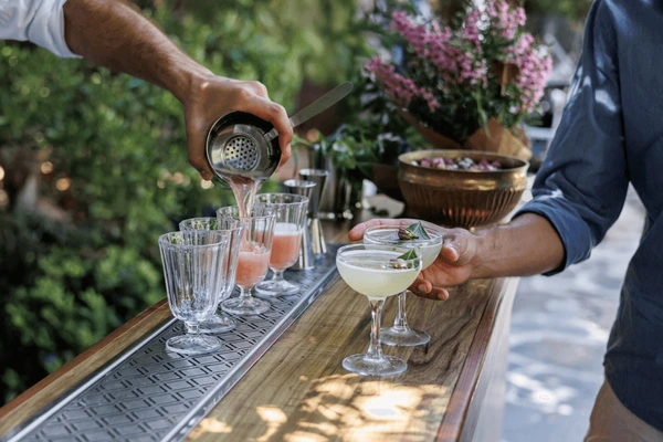Professional bartender preparing fresh cocktails outdoors